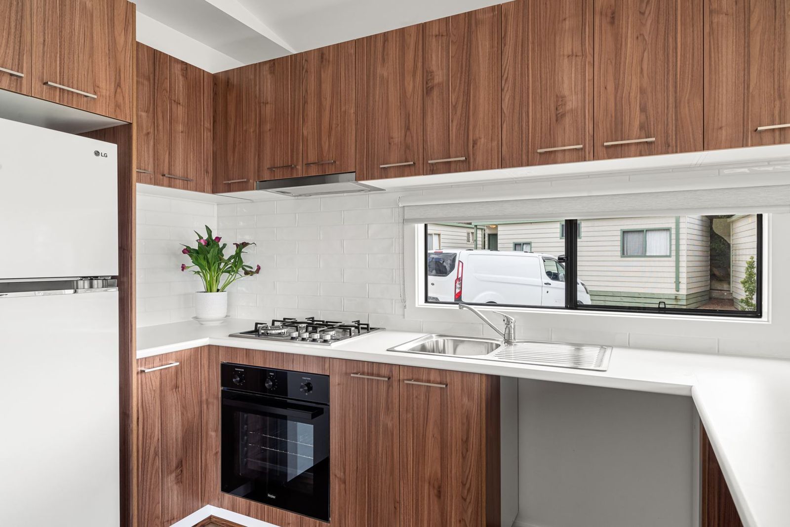 Kitchen with timber-look cupboards, gas cooktop and oven